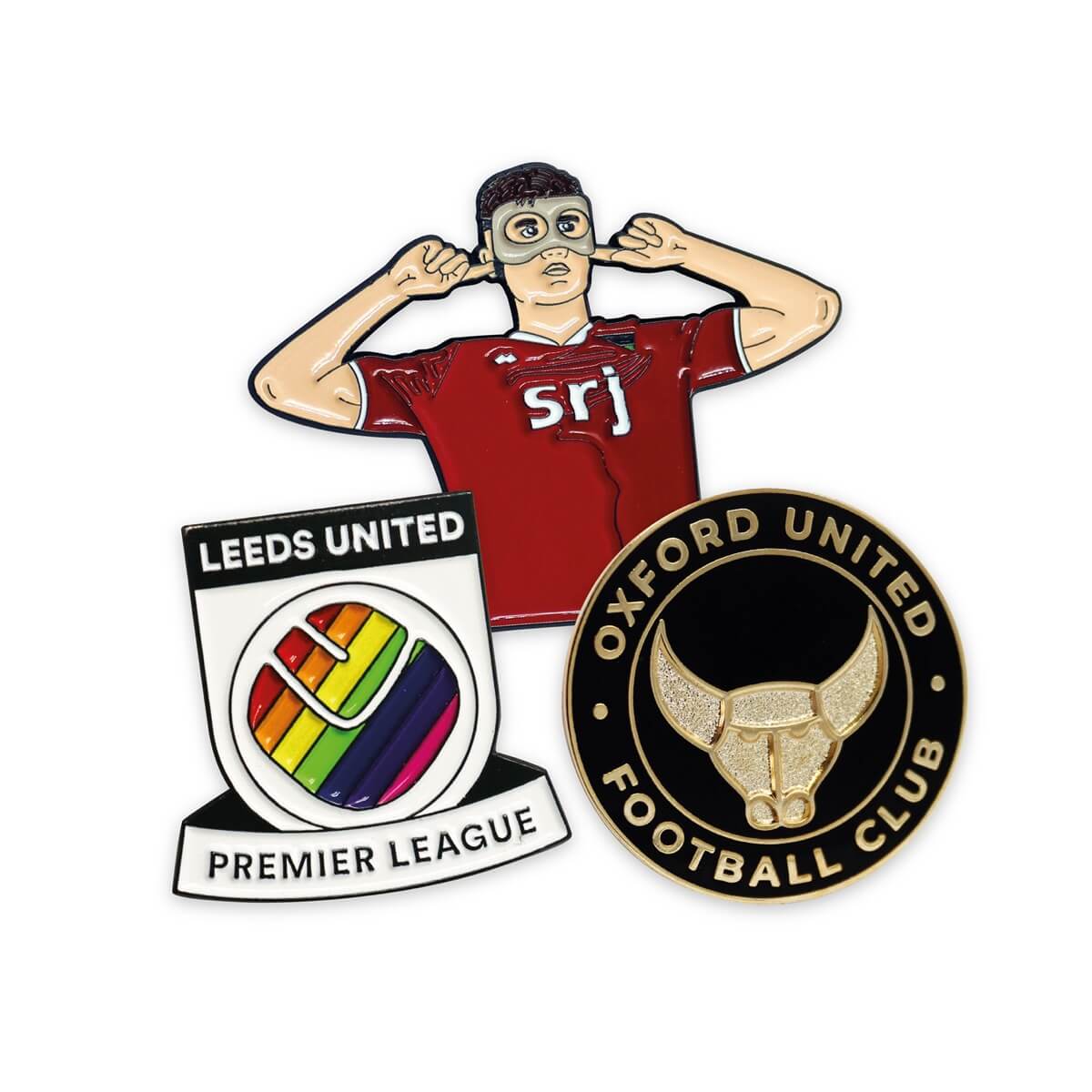 A collection of three football themed pin badges.