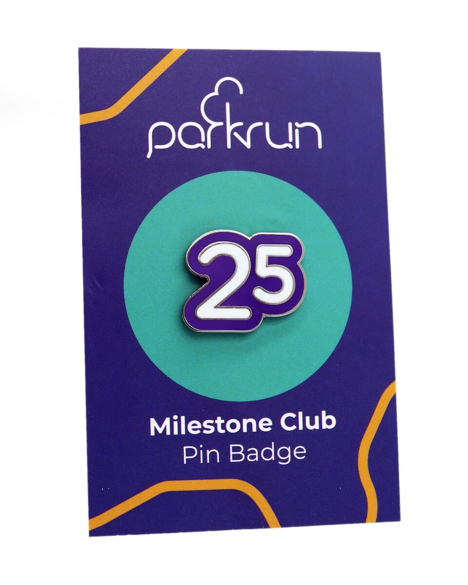 A park run enamel pin on a backing card