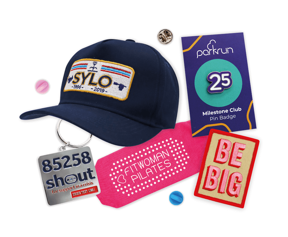 A collection of mixed merch featuring socks, pin badges, lanyards, patches and hats.