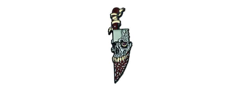 A chilling pin badge knife with a skull face blade, soul-sucking eye and razor sharp teeth.