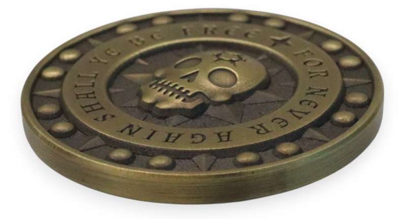 Close-up of a 3D custom coin with raised skull design, showing depth and detail compared to traditional die-struck coins.