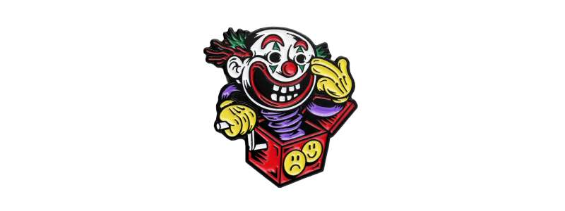 A ridiculously creepy clown pin badge with crazy eyes and horrifying toothy grin.