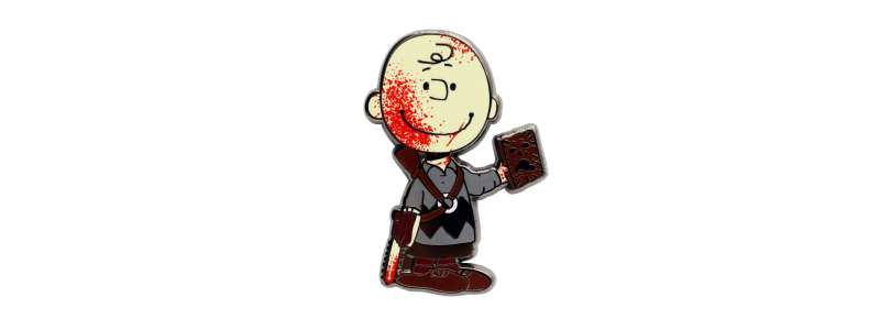 Charlie Brown covered in blood holding a chainsaw and a book, pin badge.