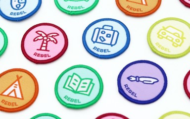 A collection of colourful woven patches for Rebel Badge Book.
