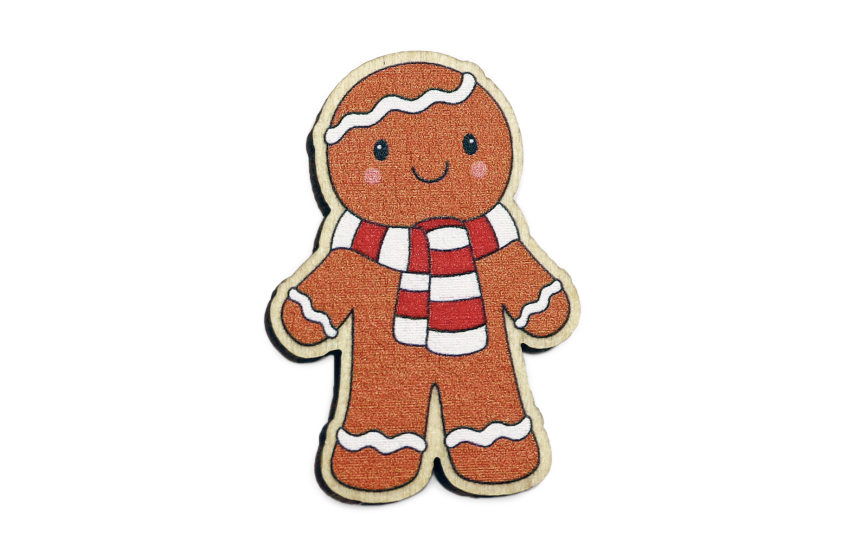 A gingerbread man wooden pin badge. It's wearing a red and white scarf and has white icing lines on his head, arms, and legs.