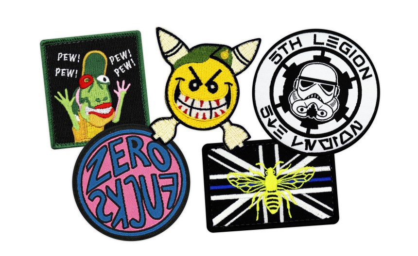 Five morale patches including a military flag patch, Star Wars patch, and smiley face bomb patch.