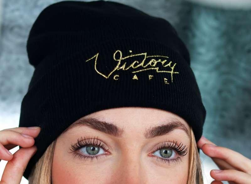 A victory care embroidered black wooly beanie.