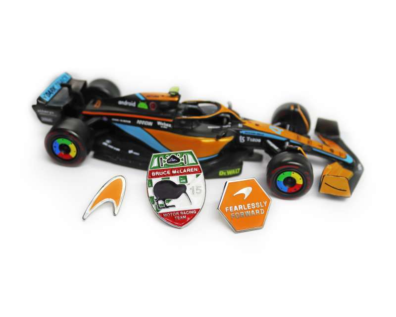 A model Formula 1 McLaren car, with three custom McLaren pin badges.