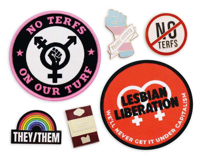 A collection of LGBTQ+ pins and patches featuring 