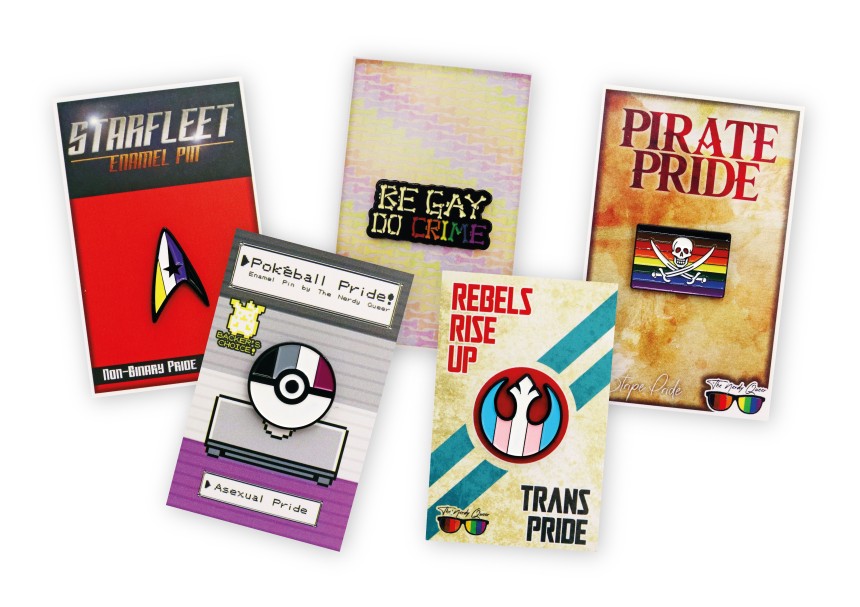 A collections of five lapel pins on backing cards featuring designs from our client The Nerdy Queer. Star trek pride pins, Star Wars LGBTQ+ badges, and Pokemon enamel products.