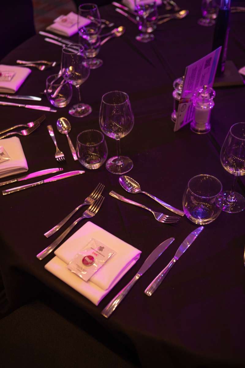 An awards ceremony table with UHA pin badges provided by Made by Cooper.