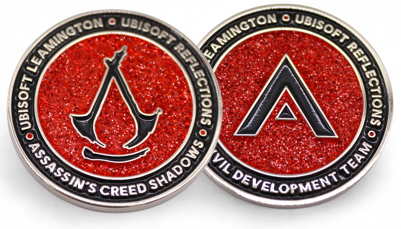 Assassin’s Creed Shadows enamel coins with the AC logo and red glitter created for the Ubisoft development team.