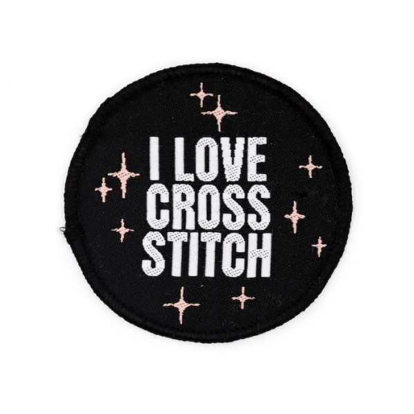 A black circular patch with the words