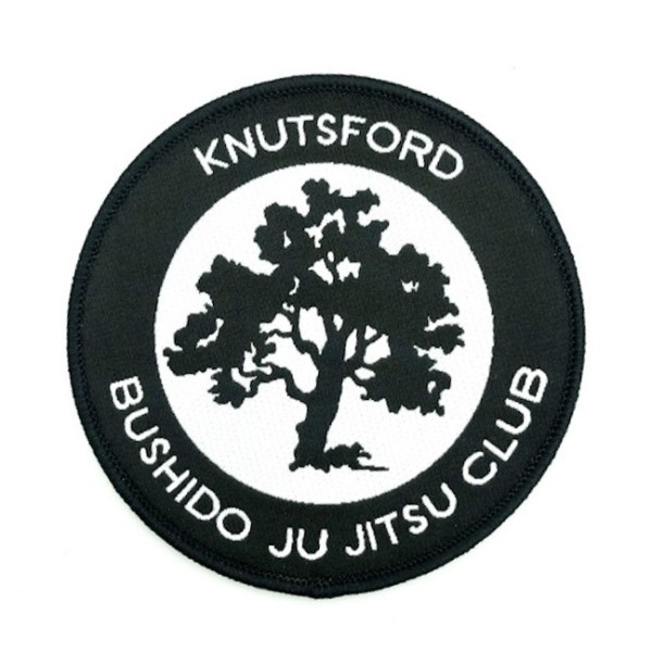 A black and white patch to represent the Knutford Ju Jitsu Club.