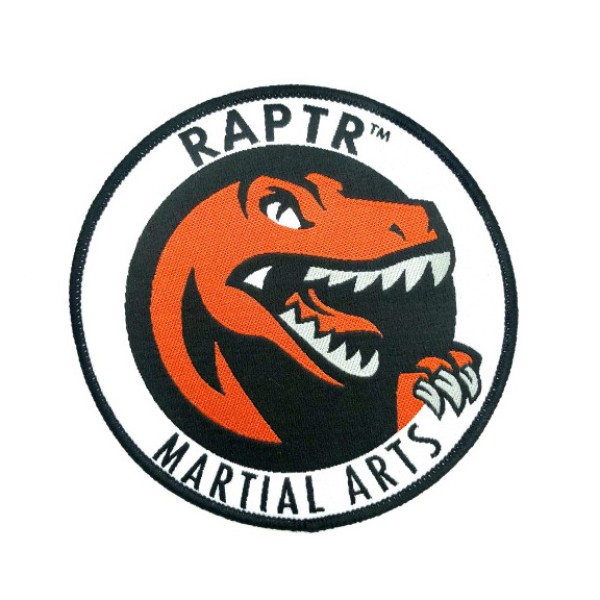 A woven patch featuring a dinosaur and the words Raptr Martial Arts Club around the edges.