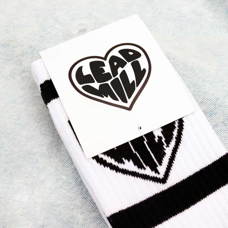 Some white custom socks with the Lead Mill love heart logo and an attached heading card.