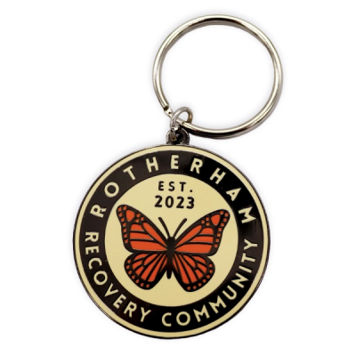 Circular hard enamel keyring featuring a butterfly emblem and community text, used as an example of commemorative hard enamel keyrings.
