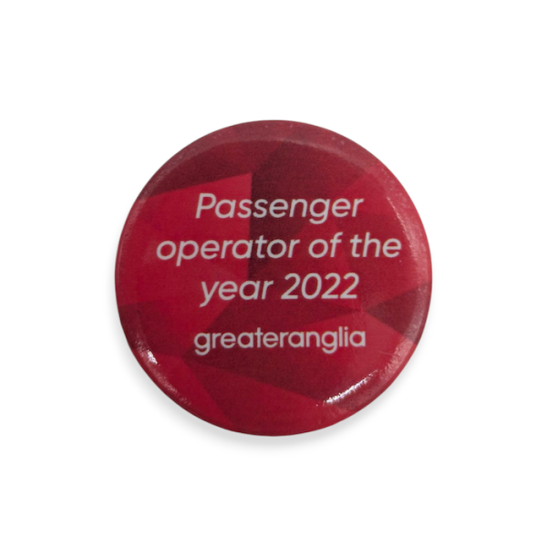 A red branded button badge with the words