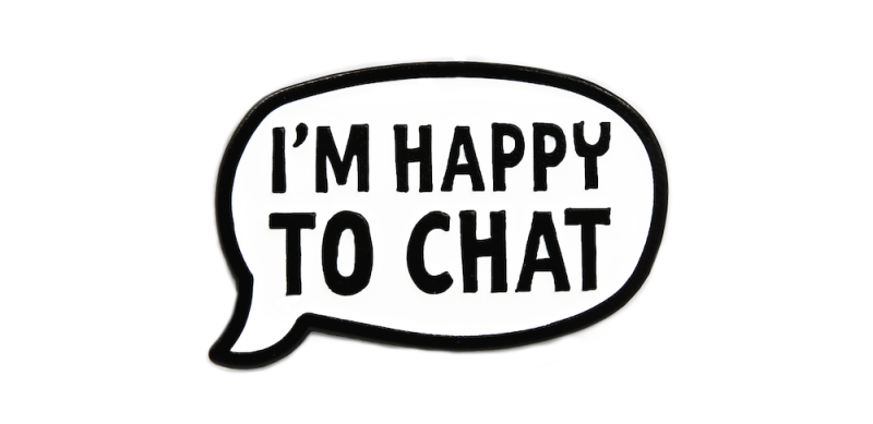 A speech bubble-shaped pin badge with a black outline that says 