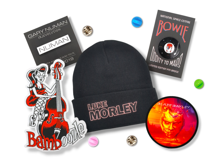 Custom beanies, pin badges, and patches to commemerate Gary Numan, Blaze Bayley, Luke Morley, and Bamboozle.