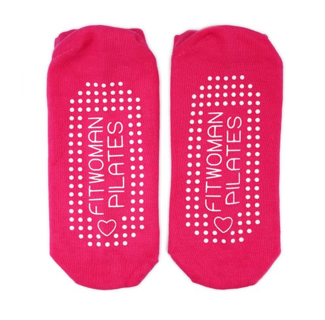A pair of pink custom branded socks. The soles of the socks have a white grip dots design with the words 