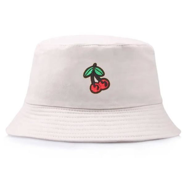 Embroidered cherries sit on the front of a white fabric bucket hat.