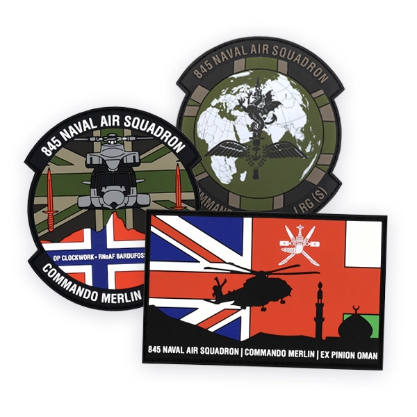 Set of military PVC patches showing 845 Naval Air Squadron and Commando Merlin designs, including helicopter graphics, world map, Union Jack and insignia, produced as durable custom PVC patches for tactical or unit use.