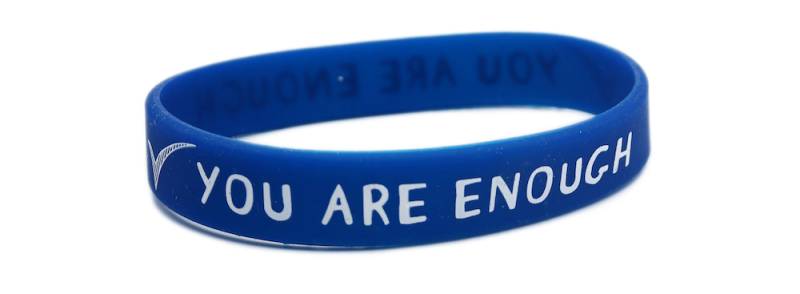 A blue silicone wristband that says 