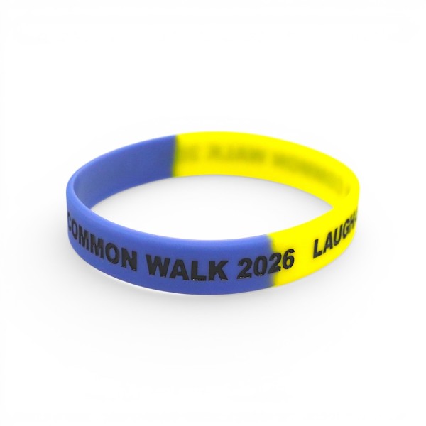 Custom silicone wristband in blue and yellow split design with debossed black text reading “Common Walk 2026”, smooth rubber finish charity event band