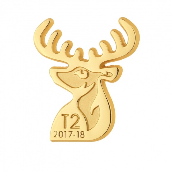 A gold plated die-struck pin badge in the shaped of a stag's head. The badge has the words