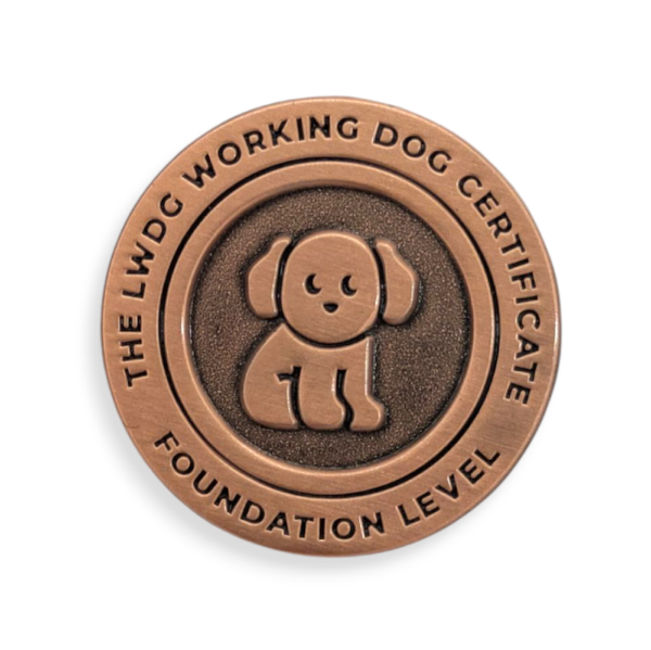 A circular die struck badge with a cartoon dog on the front.