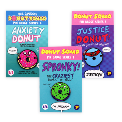 Example of custom pin badges displayed on branded backing cards, showing illustrated donut characters with enamel pin designs, used to demonstrate styles, artwork and presentation options for custom pin badges.