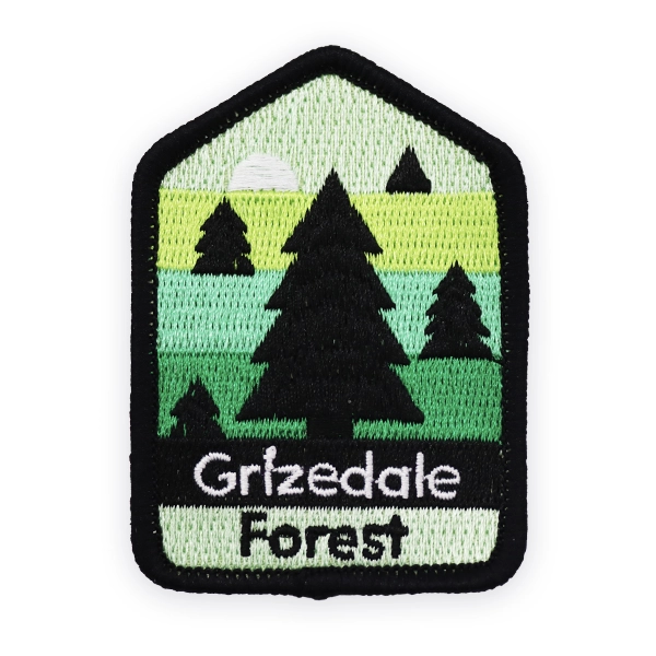 Embroidered patch showing a forest landscape with trees, hills and layered green tones, featuring Grizedale Forest text, created as a detailed custom embroidered patch for walking, hiking and outdoor themed collections.