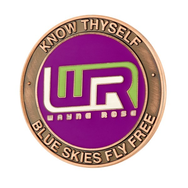 A purple enamel challenge coin that has a