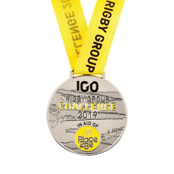 A soft enamel custom medal featuring the Rigby Group Challenge logo and a yellow ribbon