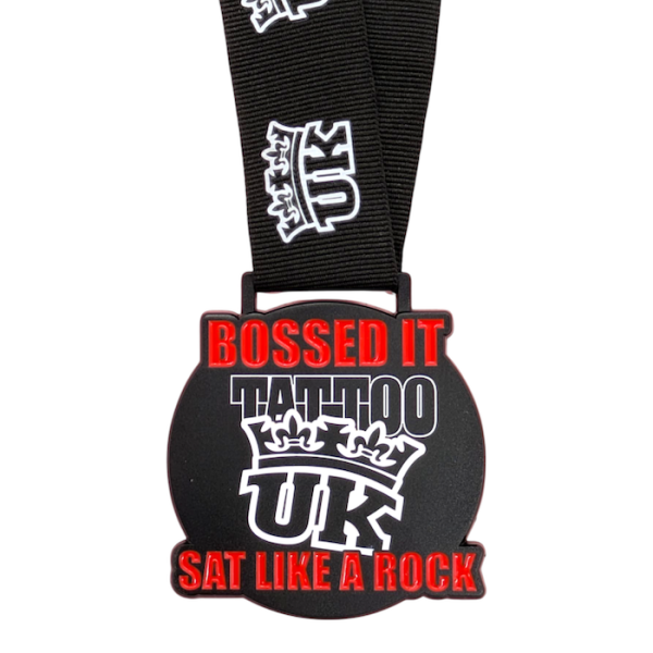A black enamel medal with black ribbon with the