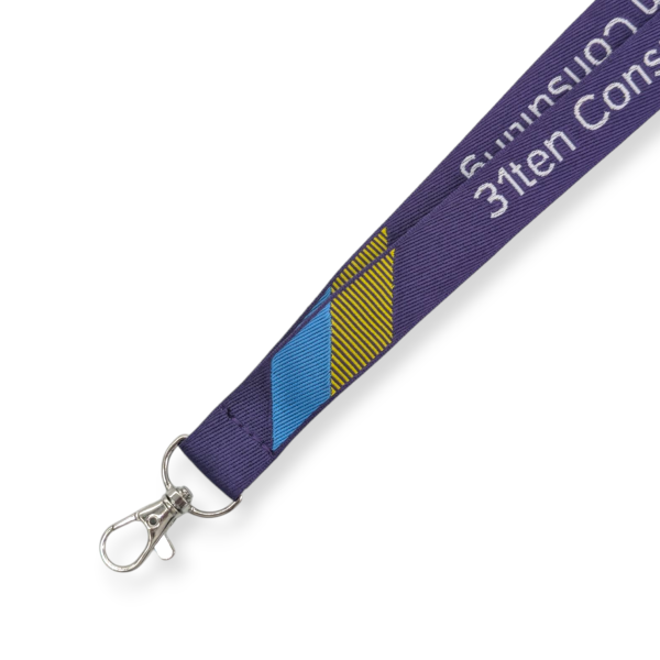 A purple woven lanyard with a light blue and yellow pattern and white text.