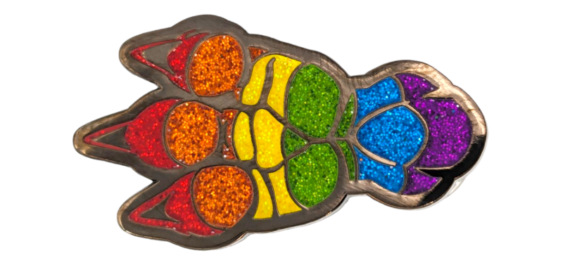 An animal paw pin badge where each section is coloured in by a different enamel glitter.