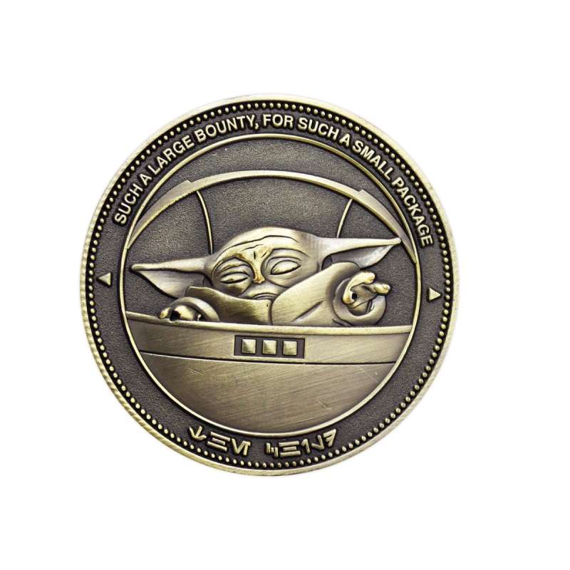 A golden challenge coin featuring Grogu from The Mandalorian. 