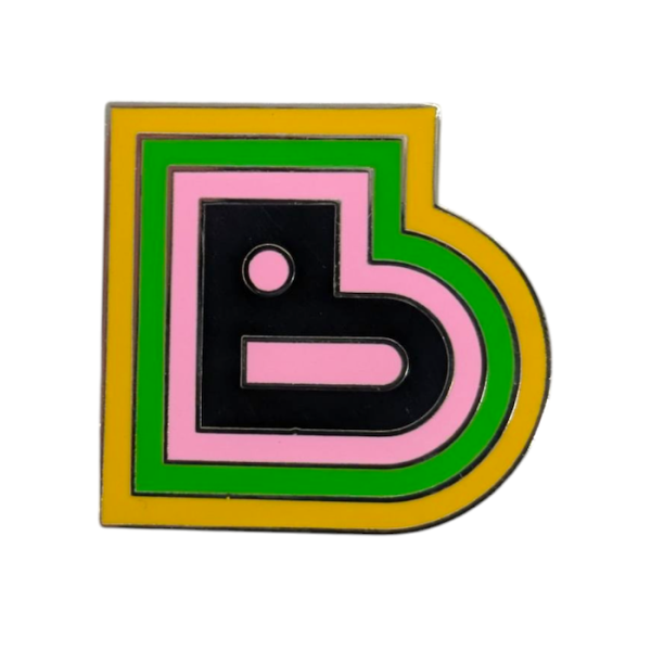 A large letter B hard enamel pin, it's vibrant and has multi-coloured layers around the B.