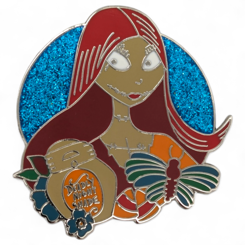 A character from Nightmare Before Christmas pin badge. The woman has flowing red had, a scarred mouth and there's a blue glittery background.