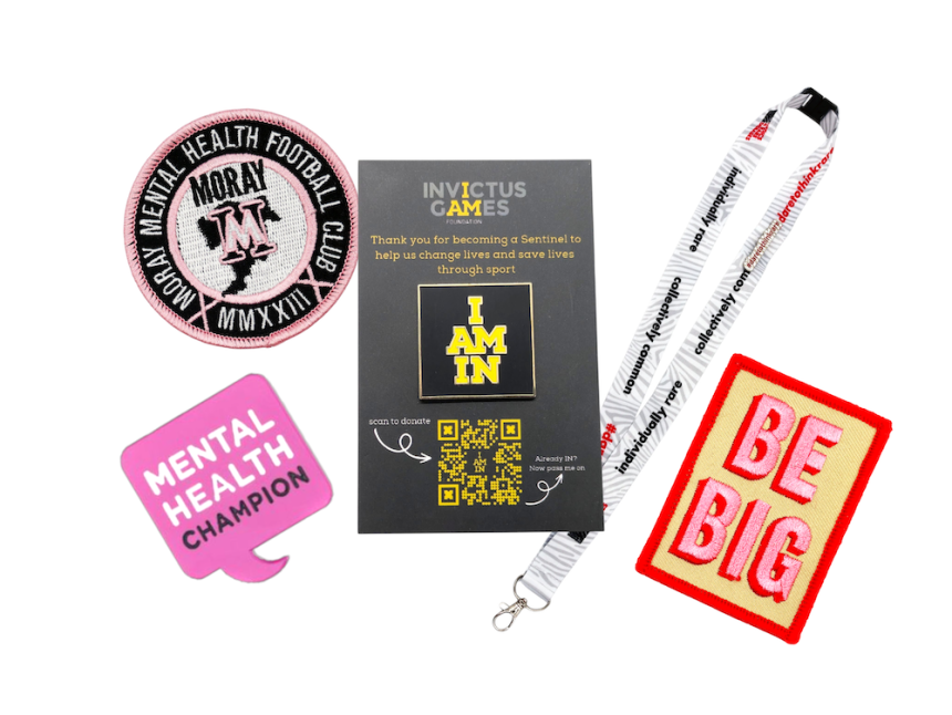 A collection of wellbeing custom merch from patches, to pin badges and lanyards.
