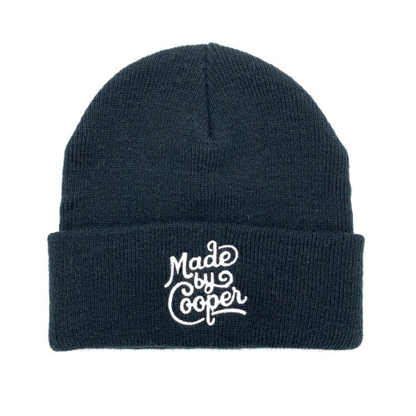 This black wooly custom beanie hat has the Made by Cooper logo embroidered on the front in white thread.