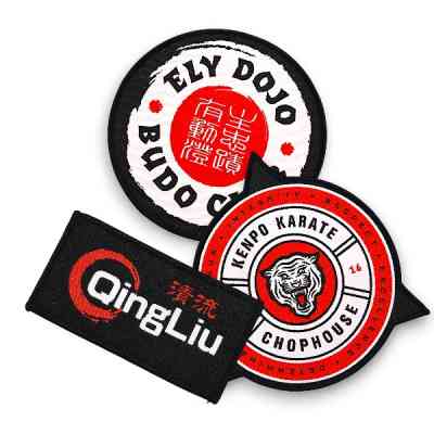 Three custom woven patches  with karate designs and club badges for UK martial arts clubs and dojos. Circular, rectangle, and custom shape designs, with red, black, and white colour pallettes.