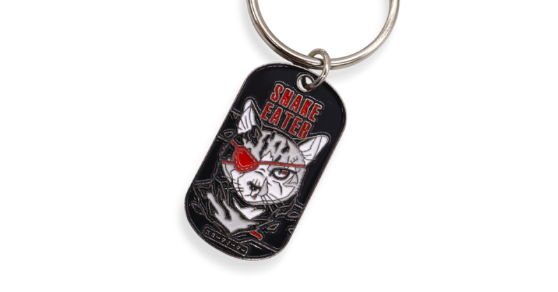 Enamel keyring inspired by Metal Gear Solid Snake Eater with stylised cat and red eyepatch design.
