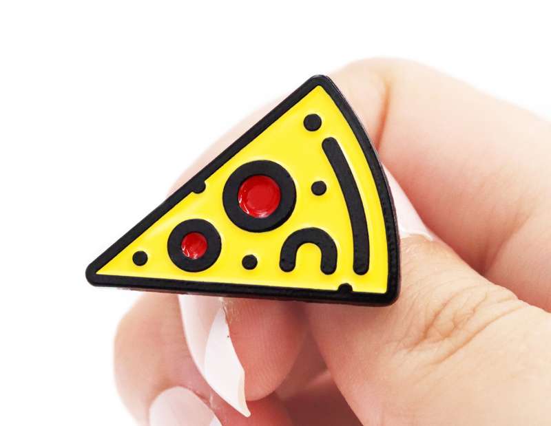 A pizza slice pin badge with 