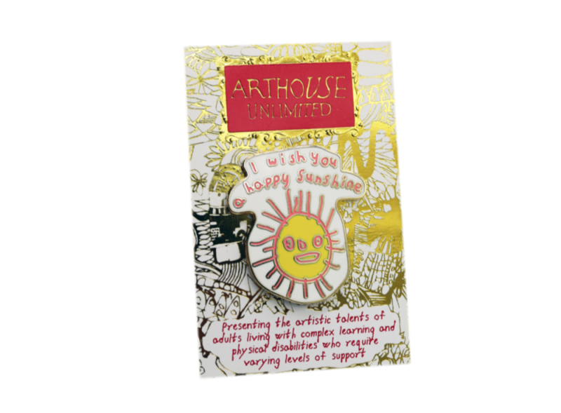 A pin badges designed by an adult with learning difficulties to promote the charity