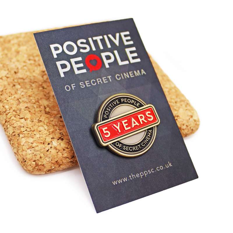 A pin badge & backing card to celebrate 5 years of the Positive People of Secret Cinema.