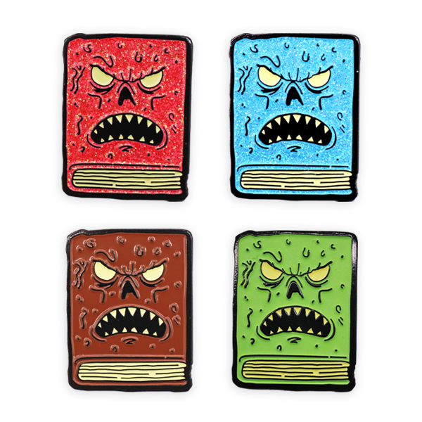 Set of soft enamel pin badges shaped like angry cartoon books in red, blue, brown and green, featuring expressive faces and textured glitter enamel, produced as colourful novelty pin badges for designers and illustrators.