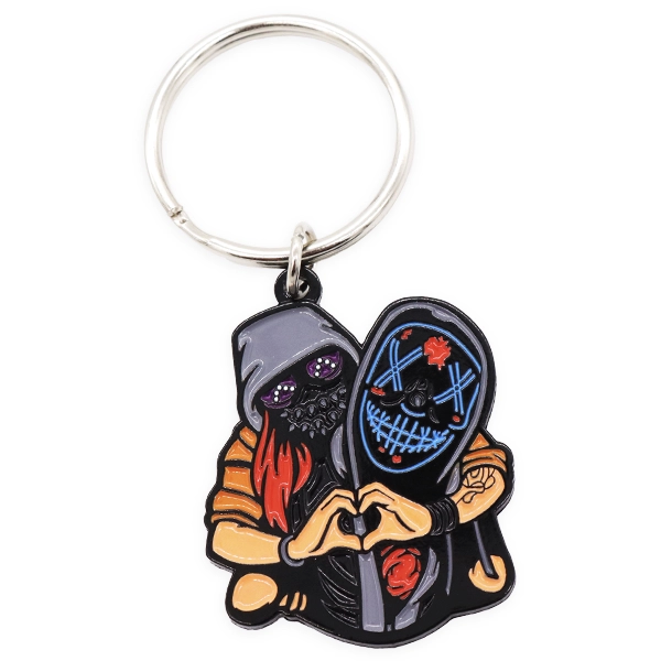 Soft enamel keyring showing two masked figures forming a heart shape, used as an example of illustrated character style soft enamel keyrings.